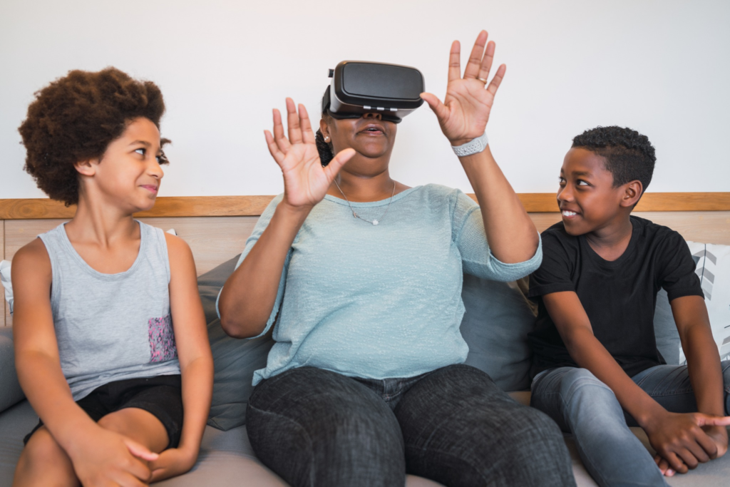 grandmother grandchildren playing together with vr glasses