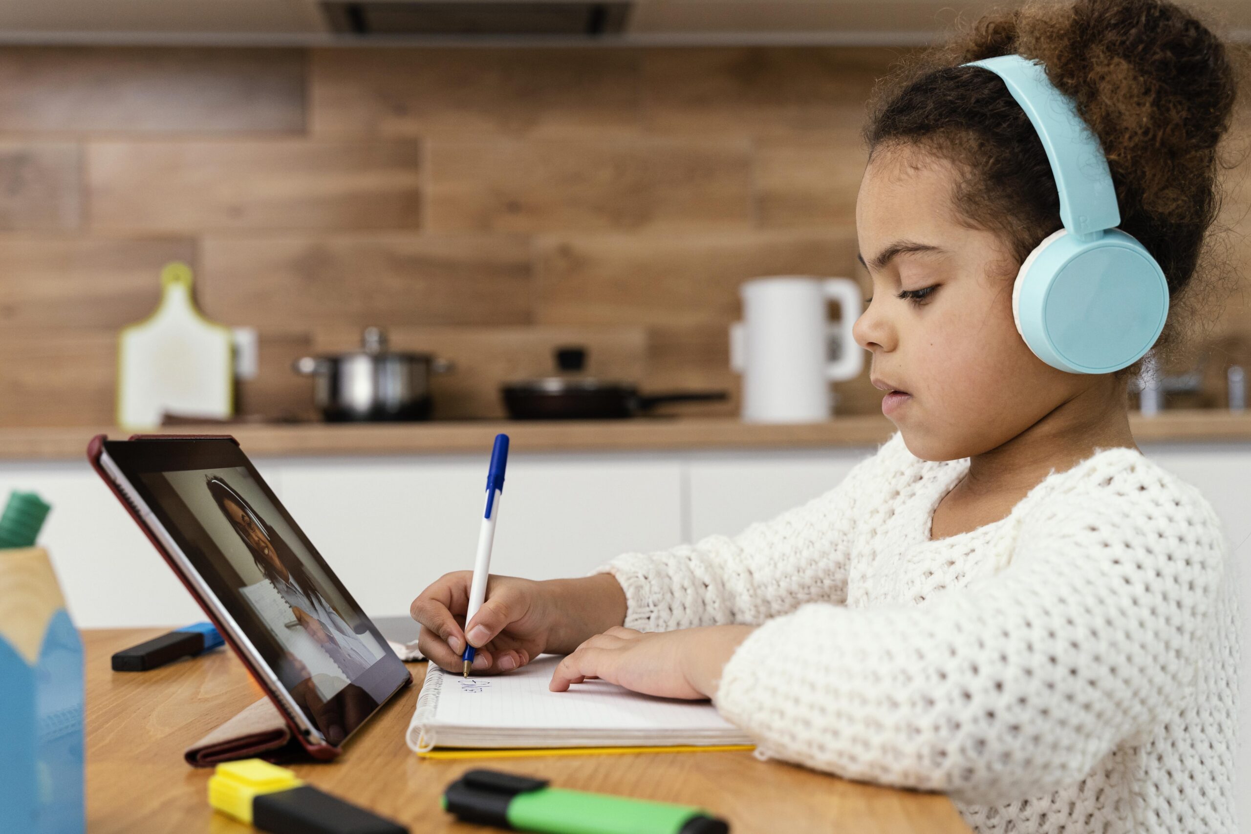 side view little girl online school with tablet